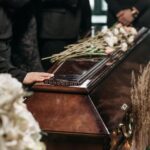 A Person Holding a Wooden Coffin